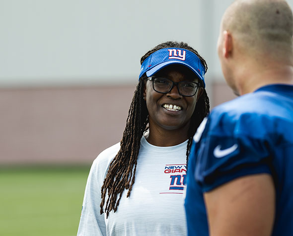 Lani Lawrence speaks with a football player