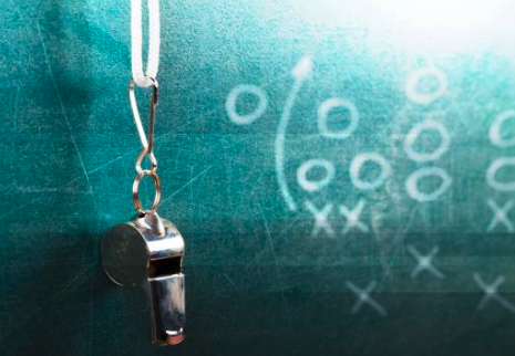 Coach whistle on a chalkboard