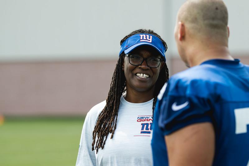 Lani Lawrence speaks with a football player