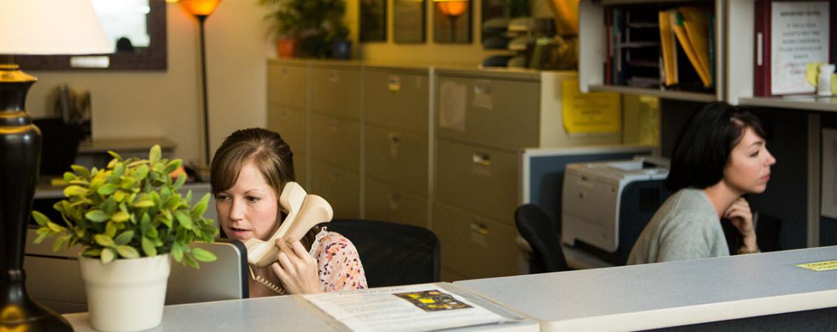 student on phone at desk