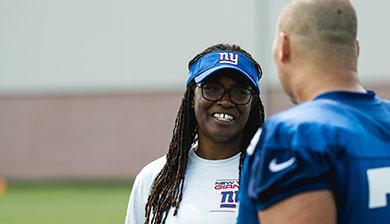 Lani Lawrence speaks with a football player